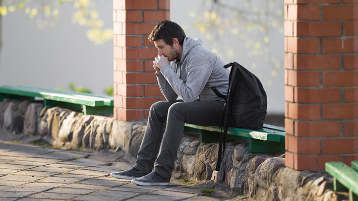 Lonely man on park bench