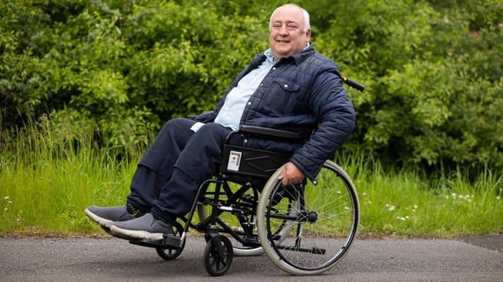 Man in Red Cross wheelchair