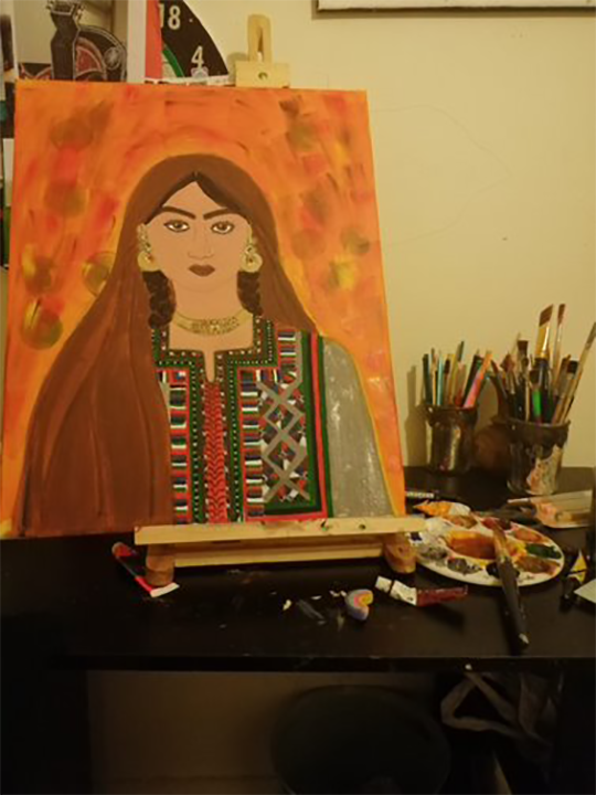 A painting of a young woman from the Middle East, sitting on an easel with paint brushes next to it.