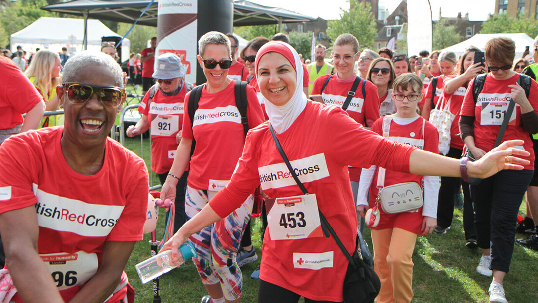 Group of walkers wearing Red Cross t-shirts set out on Walk for Humanity charity walk.
