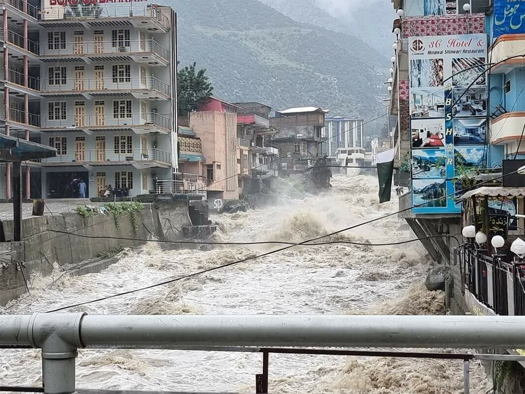 Water gushing down a city street in the Pakistan floods. Copyright Pakistan Red Crescent Society.