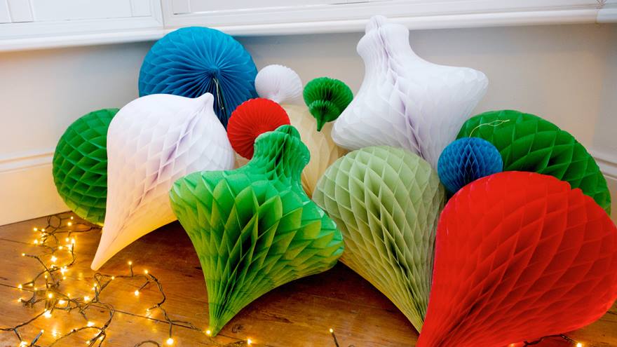 A bunch of paper Christmas decorations with ferry lights.