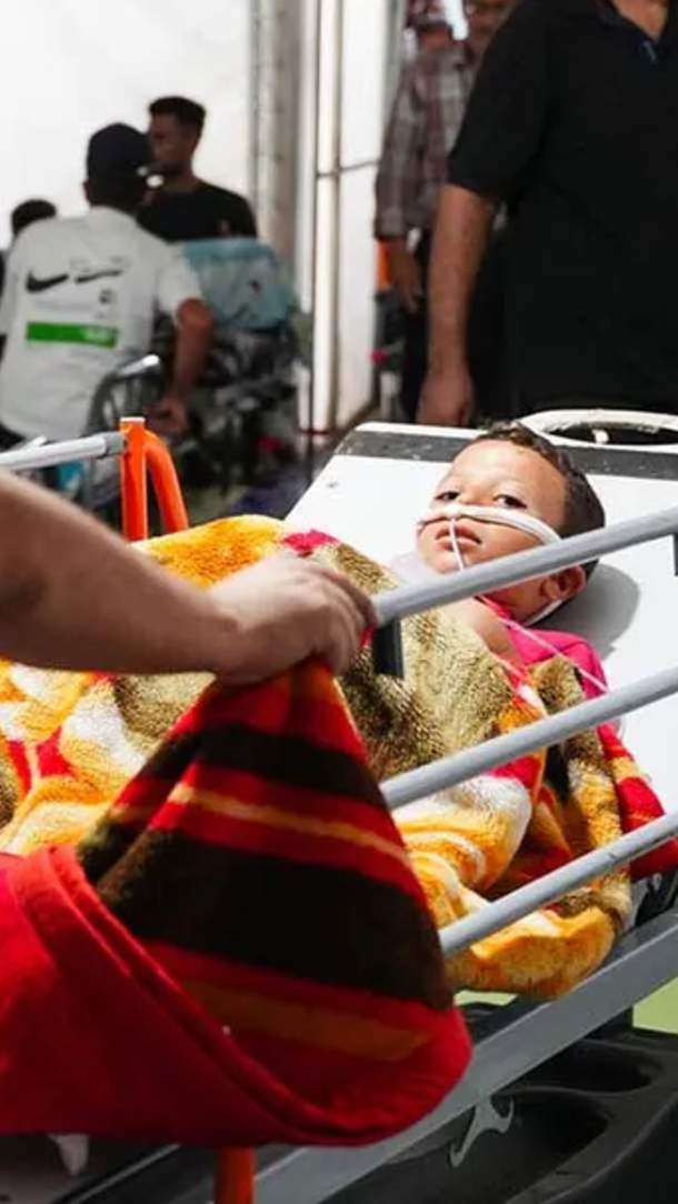A child is being treated on a hospital bed in Gaza.