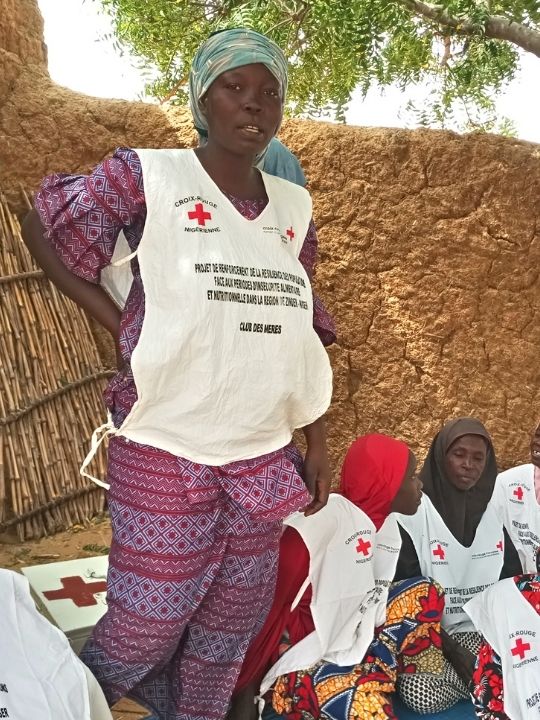 Bassiri Ida, the leader of the Kaki Fada Mother's Club, stands with her community group.  