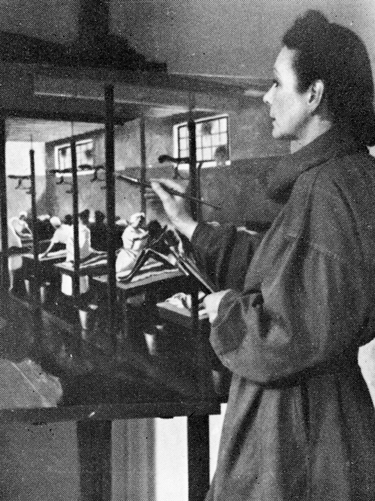 Black and white photograph of Doris Zinkeisen painting
