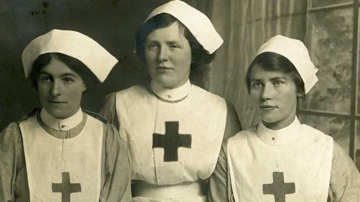 A black and white photograph, showing three first world war nurses grouped together