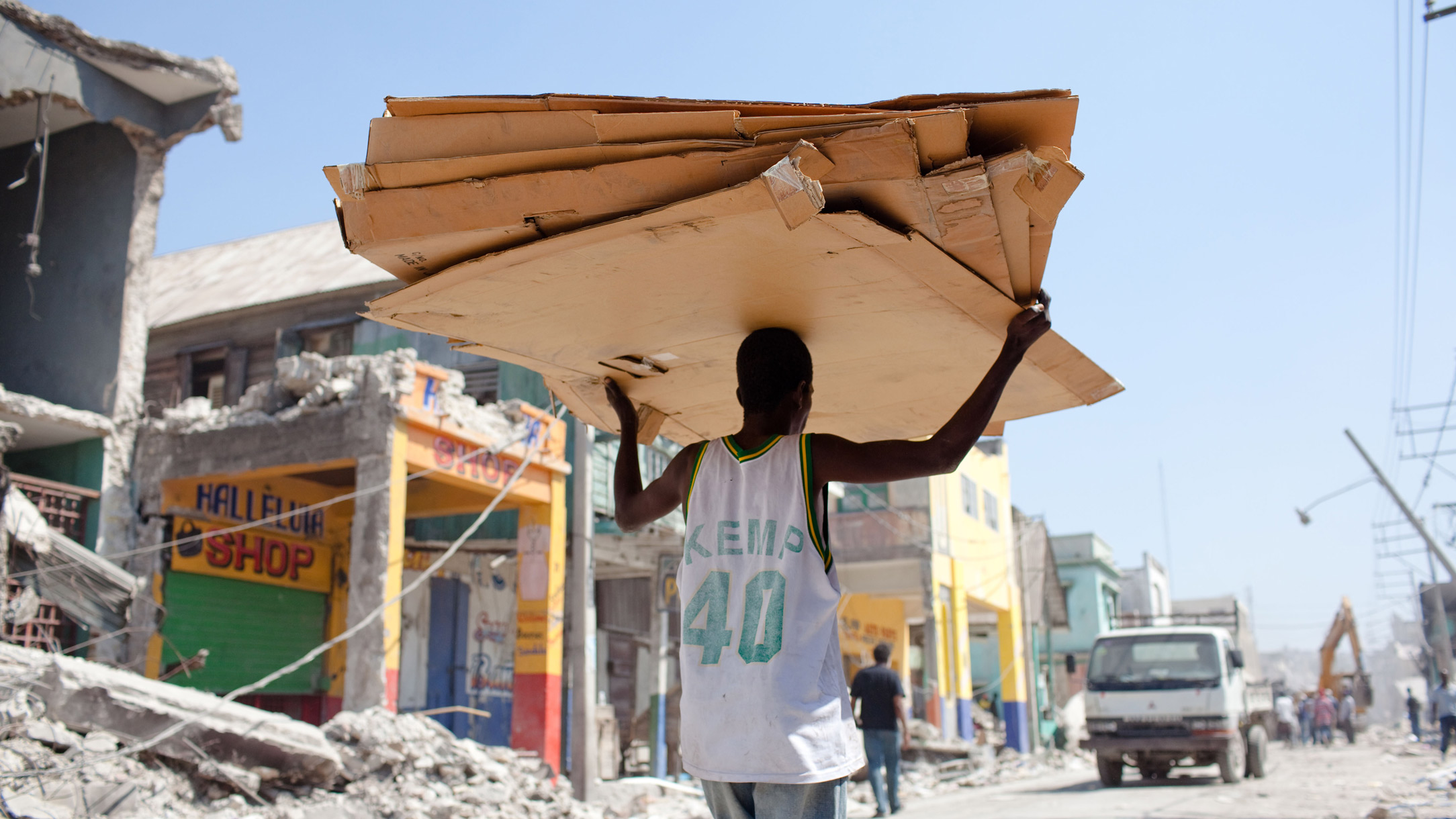 Man carries cupboard on during haiti recovery efforts