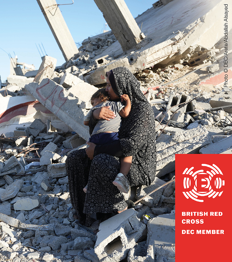 A woman sits on a pile of rubble, the remains of a destroyed house, holding a child in her lap. A graphic reads: "British Red Cross DEC Member".