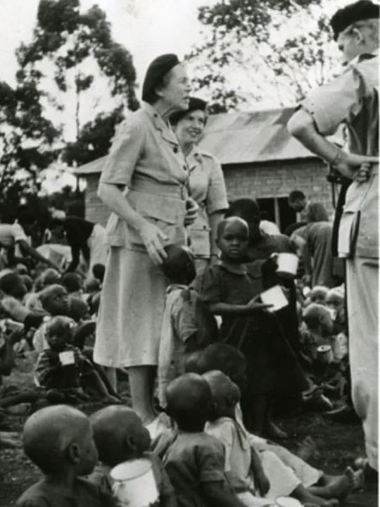A black and white photograph showing Lady Angela Limerick surrounded by children