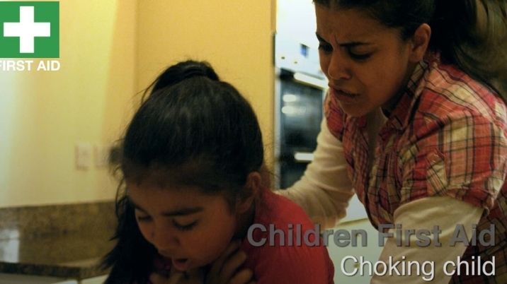 Image still form first aid video showing adult helping a child who is choking