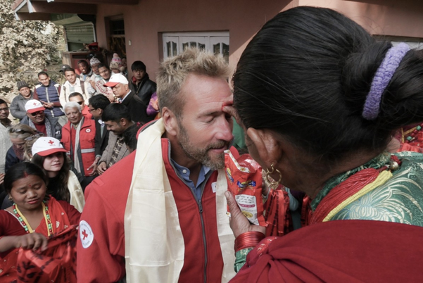 Woman applies a bindi on Ben Fogle