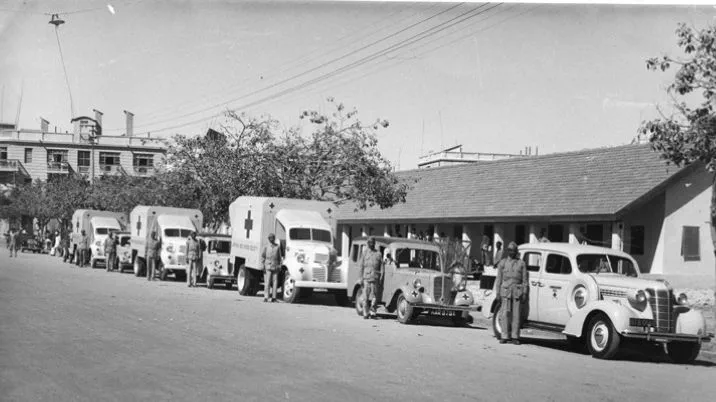 A black and white photograph showing ambulances donated by the British Red Cross during the Partitian.