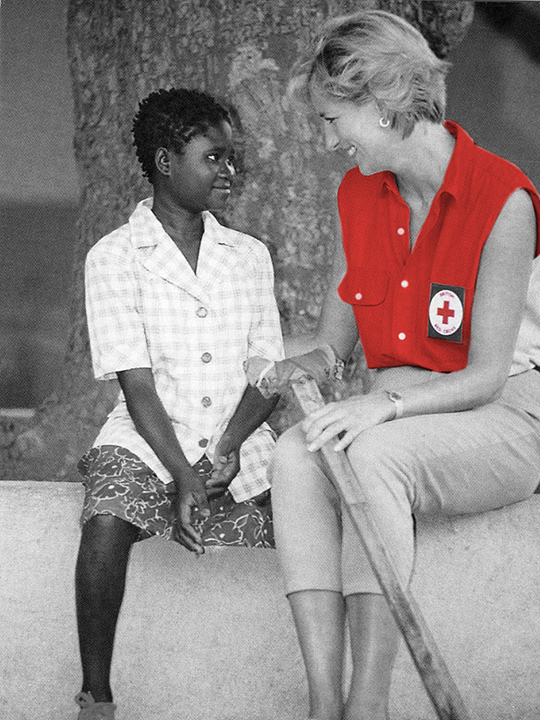 In Angola, Princess Diana speaks to a landmine survivor who lost her leg.