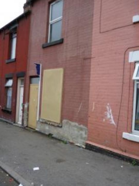 Refugee housing in Sheffield - derelict house with boarded up windows