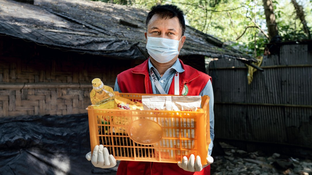 Mohammed holds a crate of food items