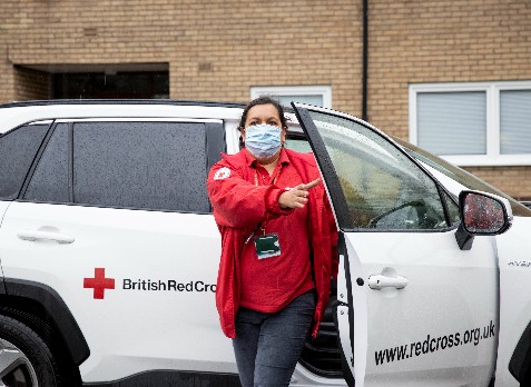 Natalie steps out of a British Red Cross car