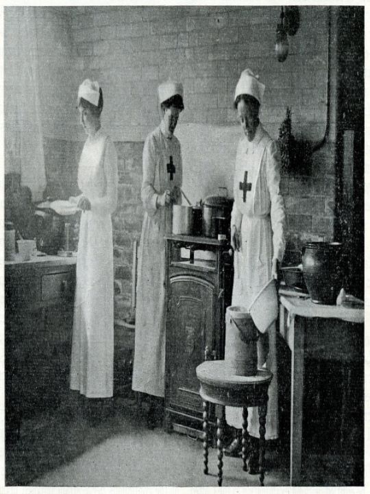 Three volunteers preparing a meal at a Red Cross hospital