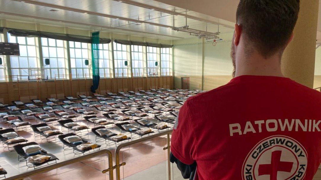 A volunteer from the Polish Red Cross looks out at a temporary accommodation shelter set up for people arriving from Ukraine