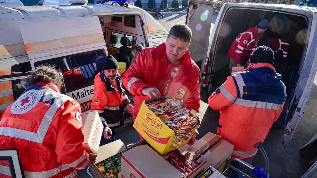 Ukrainian Red Cross staff and volunteers sort through food packages to take to some of the 8,000 people who are sheltering in a subway station in Kyiv.