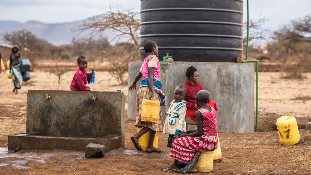 Carolyne visits one of the new tanks installed by the Red Cross to collect water for her family in Kenya, enduring ongoing drought in Africa.