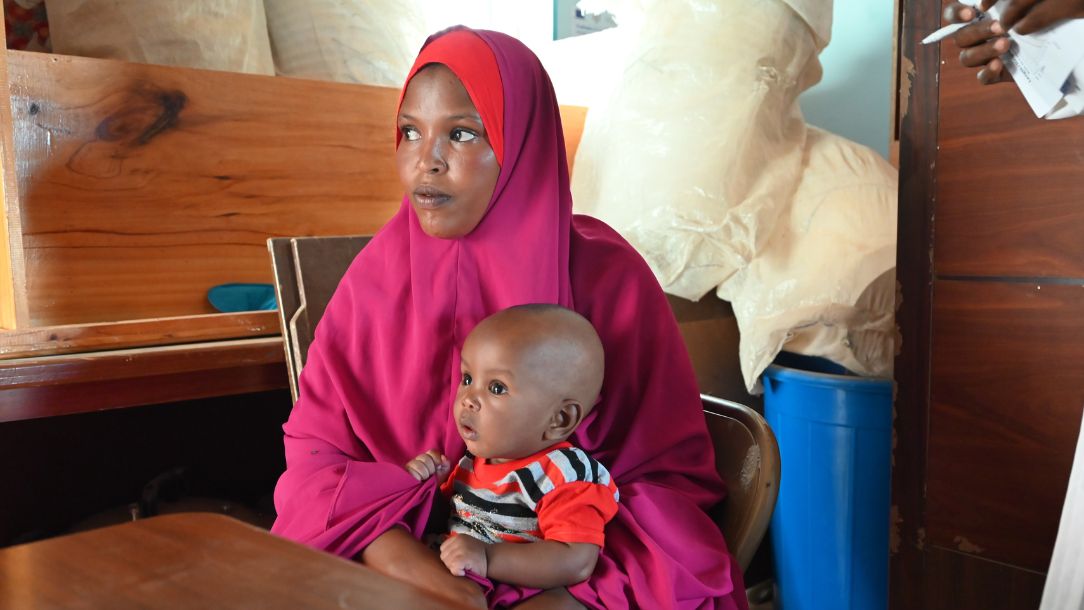 A child visits a health clinic with their mother after suffering extreme hunger.