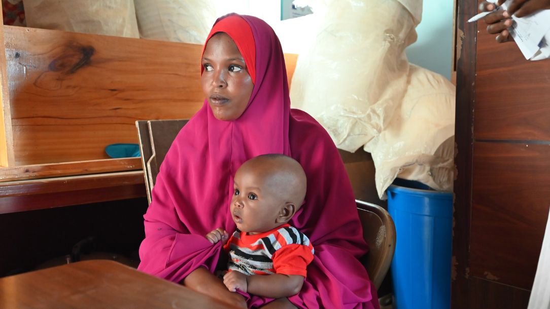 A child visits a health clinic with their mother after suffering extreme hunger. 