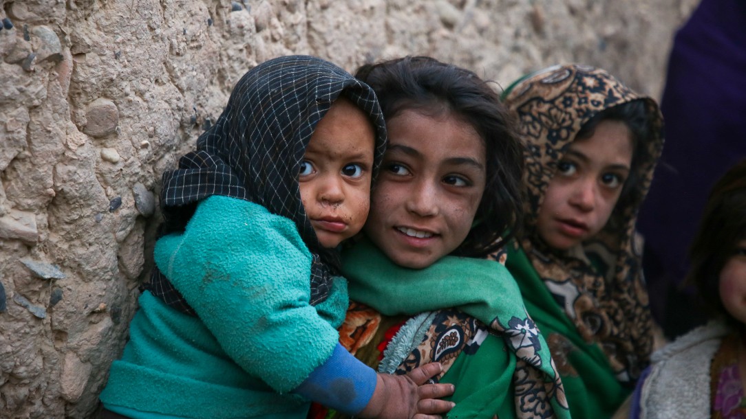 Children in Helmand Province, Afghanistan, wait for an Afghan Red Crescent food distribution.