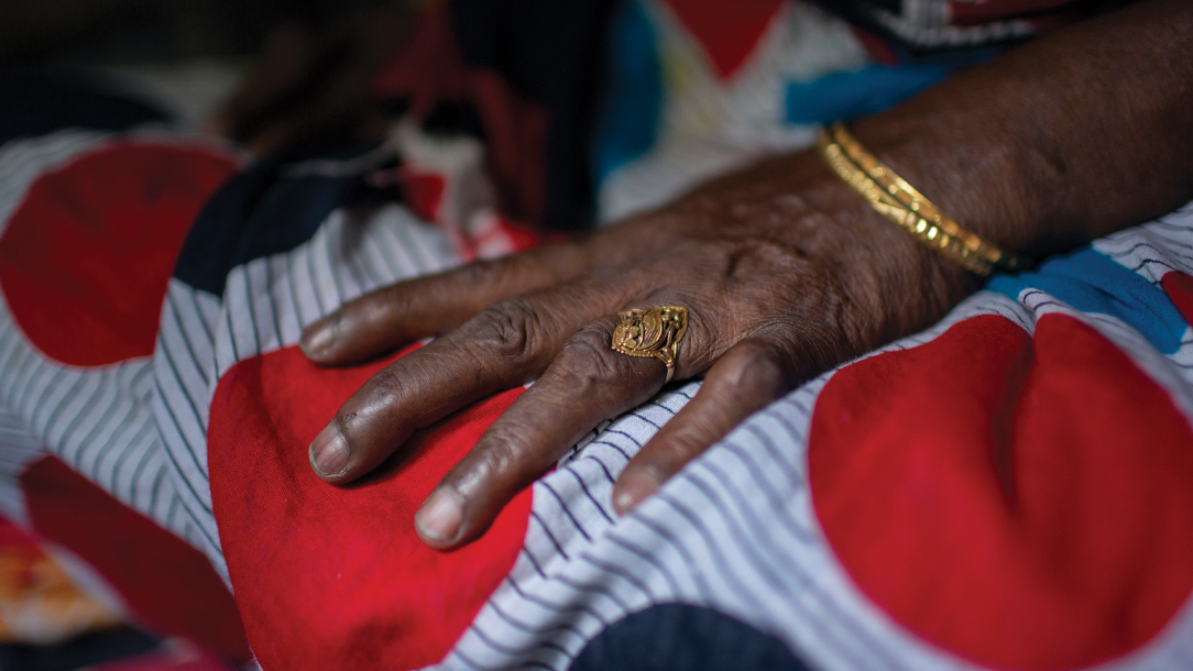 Amirjaan's hand jewellery. She wears a gold ring and two bangles.