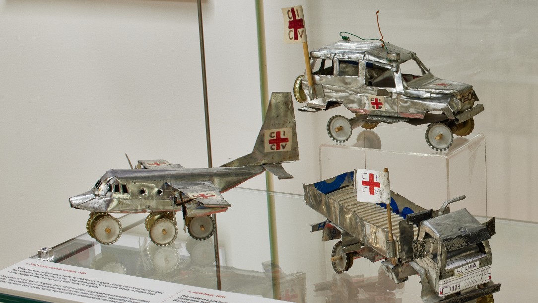 Miniature vehicle models made by children in Angola, mainly out of Red Cross food aid tins. 