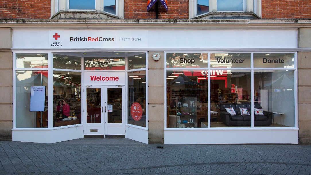 A picture of a British Red Cross shop in Redhill. The shop specialises in furniture.