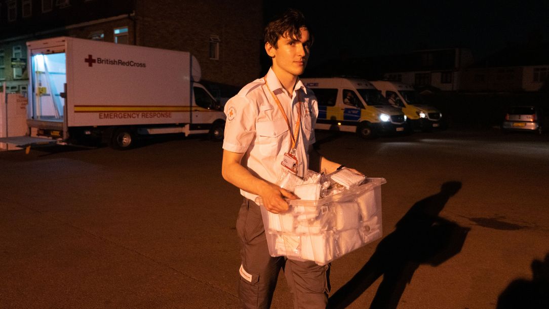 A British Red Cross volunteer supports people affected by the grassfires in Dagenham, East London.
