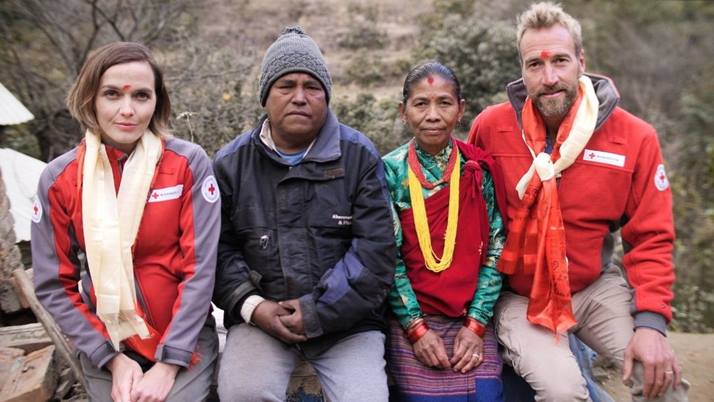 Dressed in British Red Cross hoodies, Victoria Pendleton and Ben Fogle sit with a Nepalese woman called Masali and a member of her family.