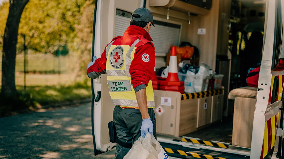 Red Cross volunteer Ashley loads supplies on to van
