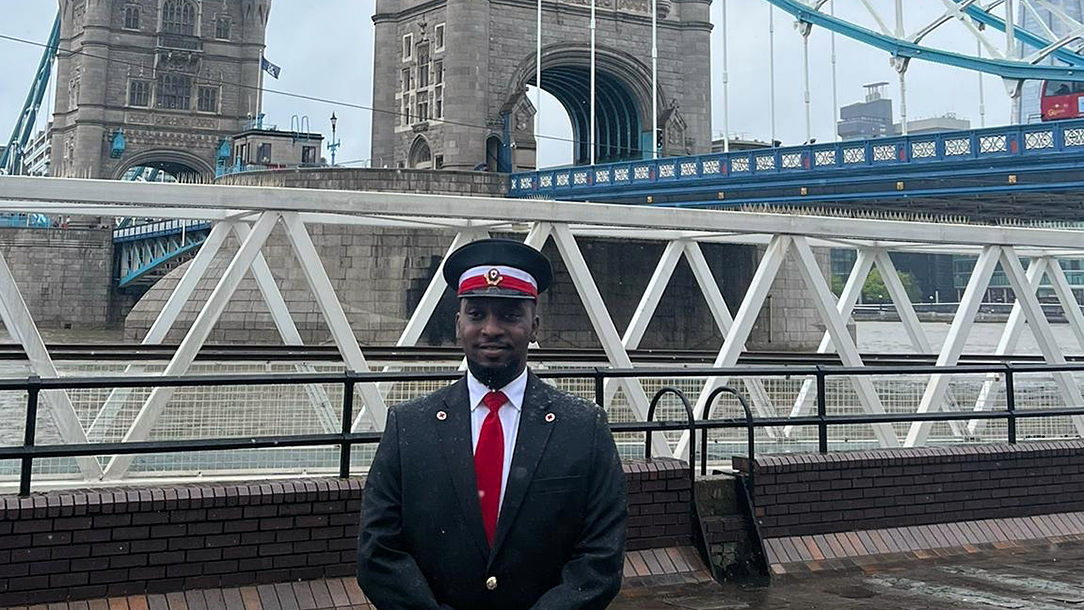 Mohammed stands in front of Tower Bridge, London before King Charles procession.