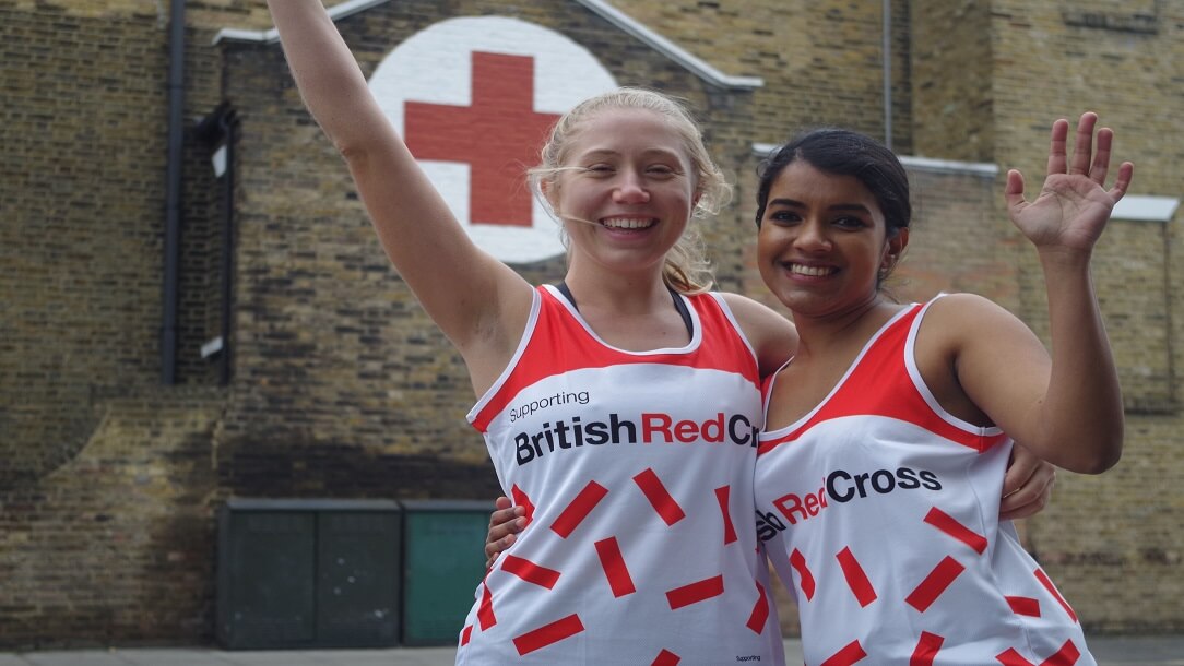 Two runners cheering outside the Hackney Refugee centre
