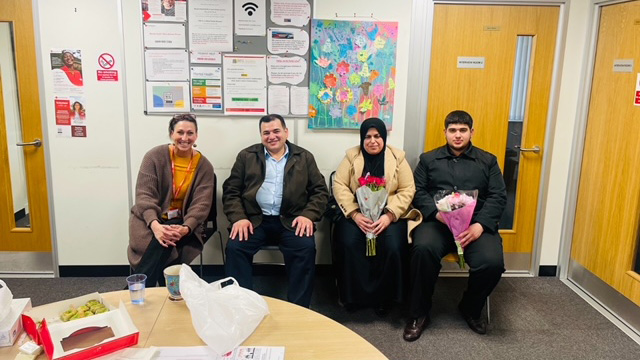 Ali, Chnoor and Ayub in the Refugee Support office in Leicester after being reunited.