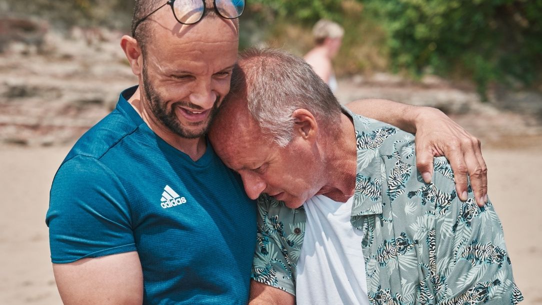 Olympian Jamie Baulch helps Gareth into the sea.