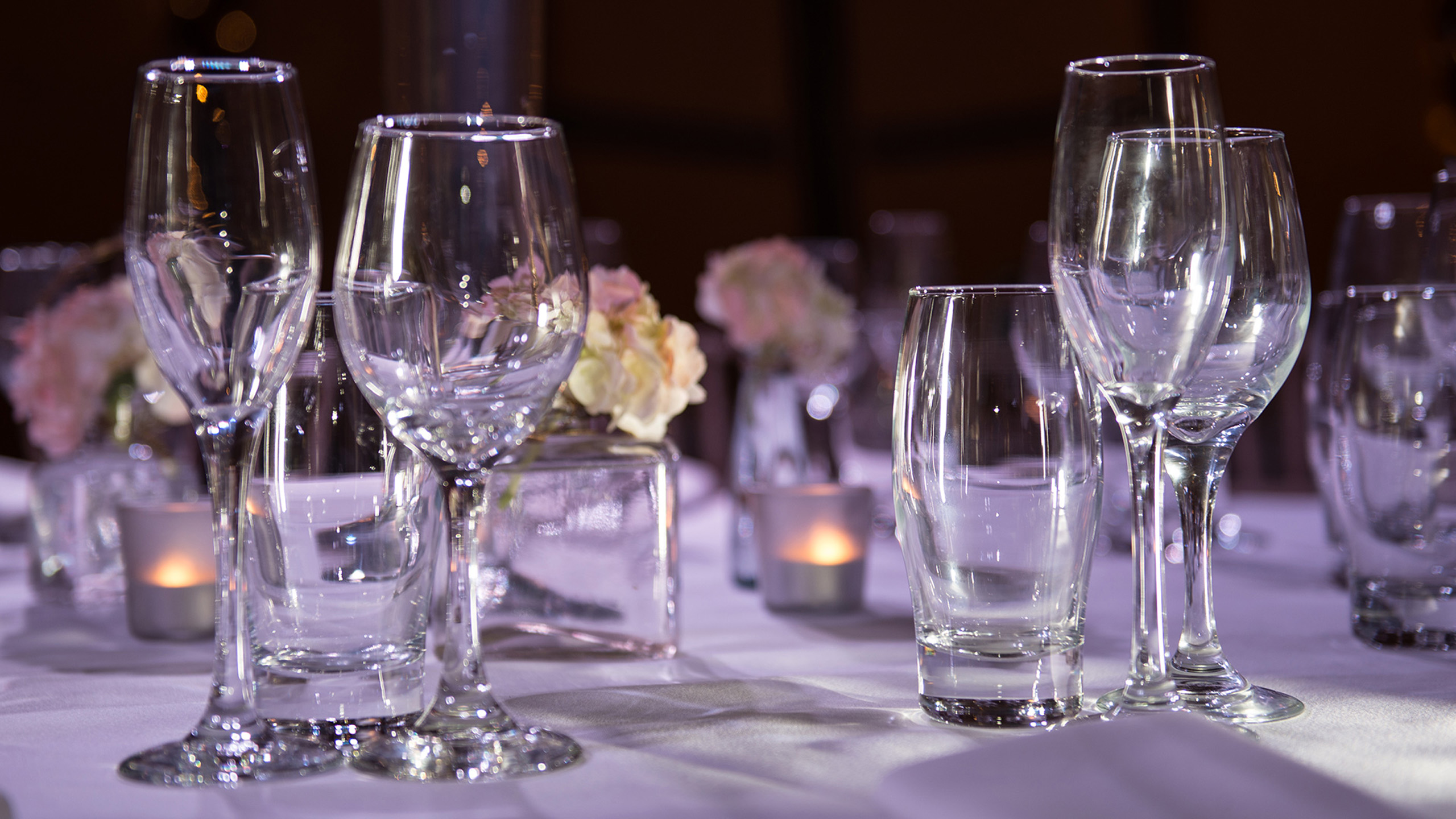 Table with glasses set for formal dinner