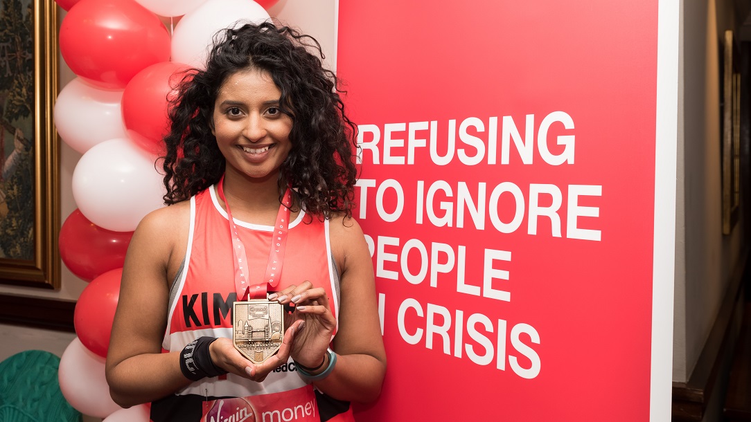 Lady holding her medal after completing the event.