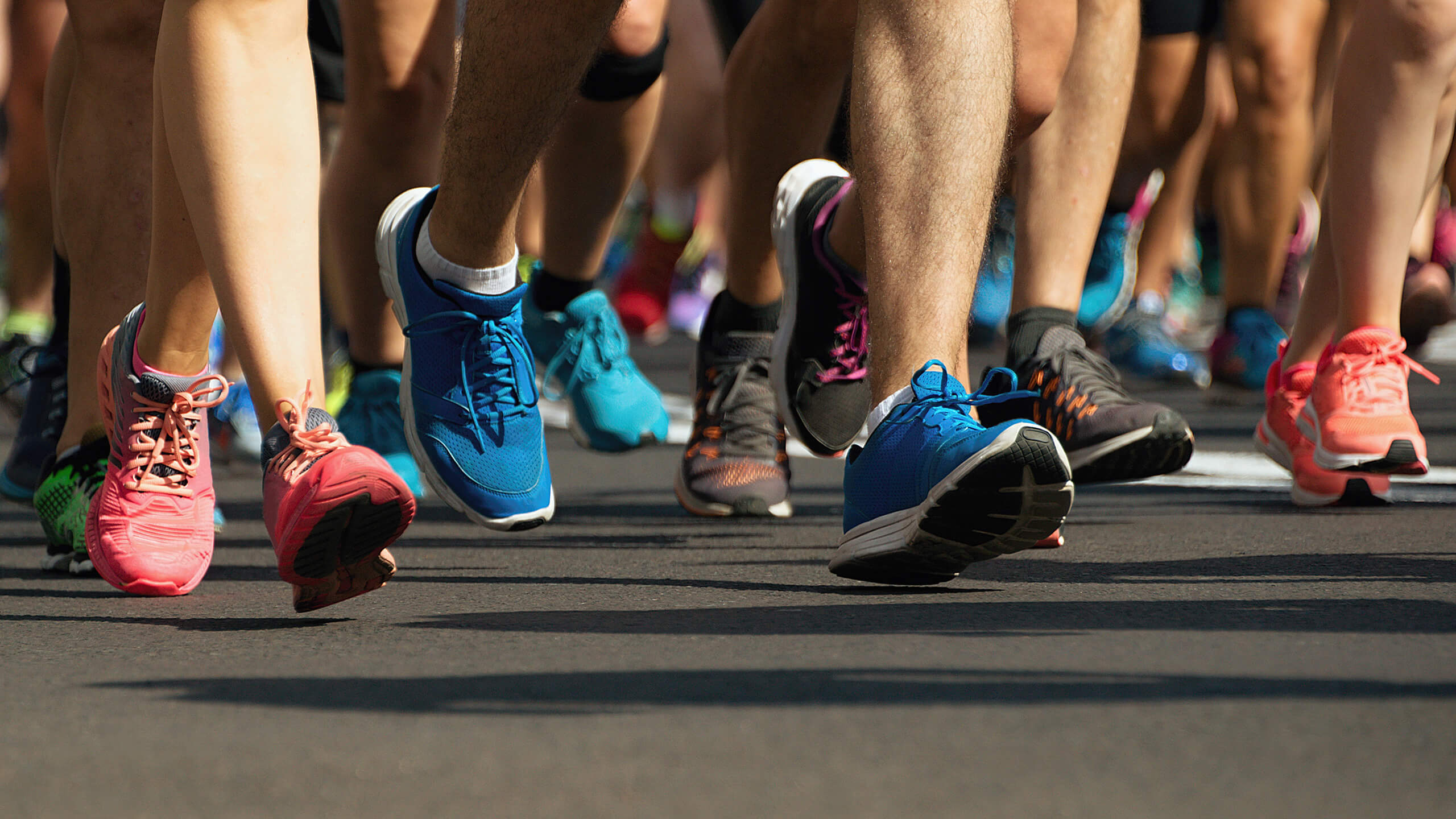 event runners wearing sneakers on footpath event detail shot
