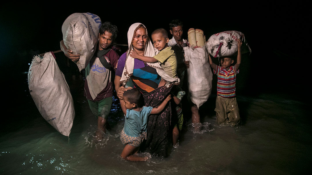 A group of Rohingya people arrive by boats in the safety of darkness on 26 September 2017 on Shah Porir Dwip island, Bangladesh.
