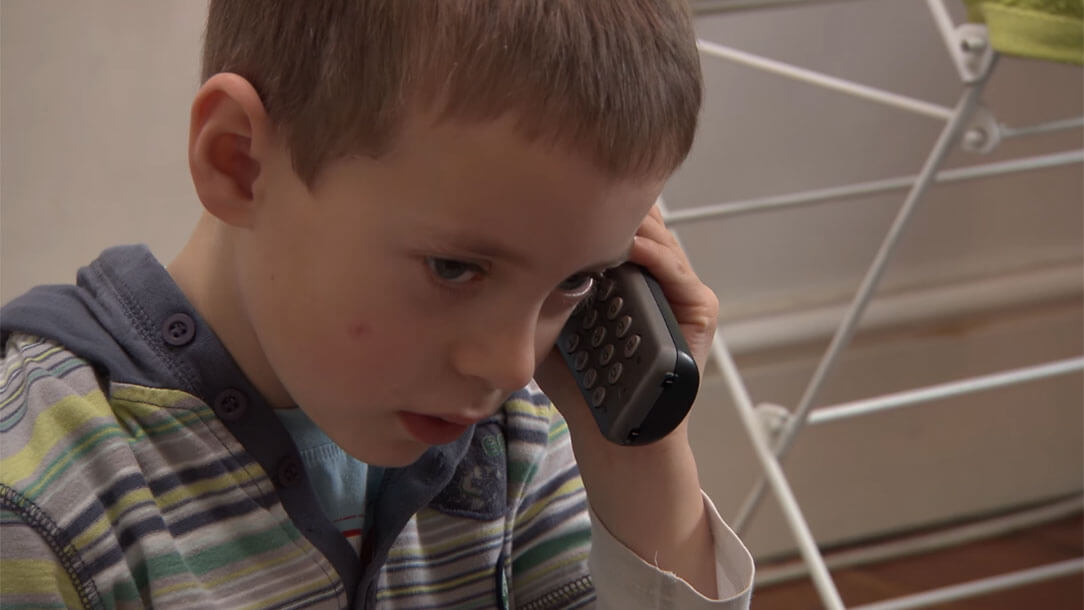 Child utilising mobile phone