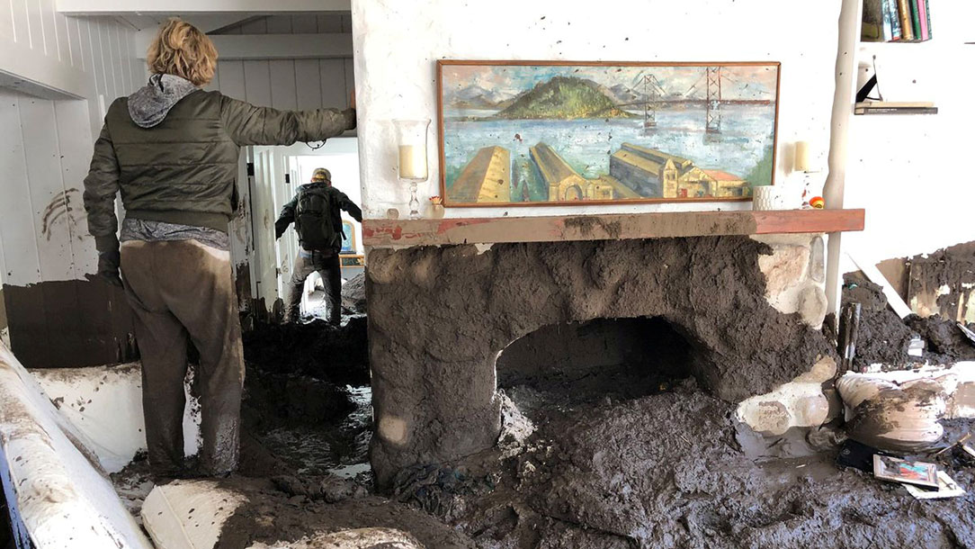 Family members inspect their home covered in mud following the mudslides in Montecito.