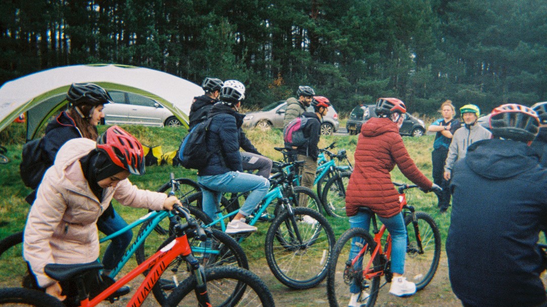A group of young people set off on a bike ride together 