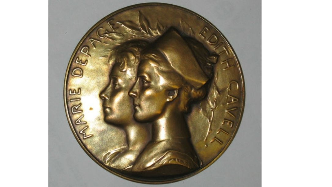 Photograph of a gold coin depicting British Red Cross nurse Edith Cavell.