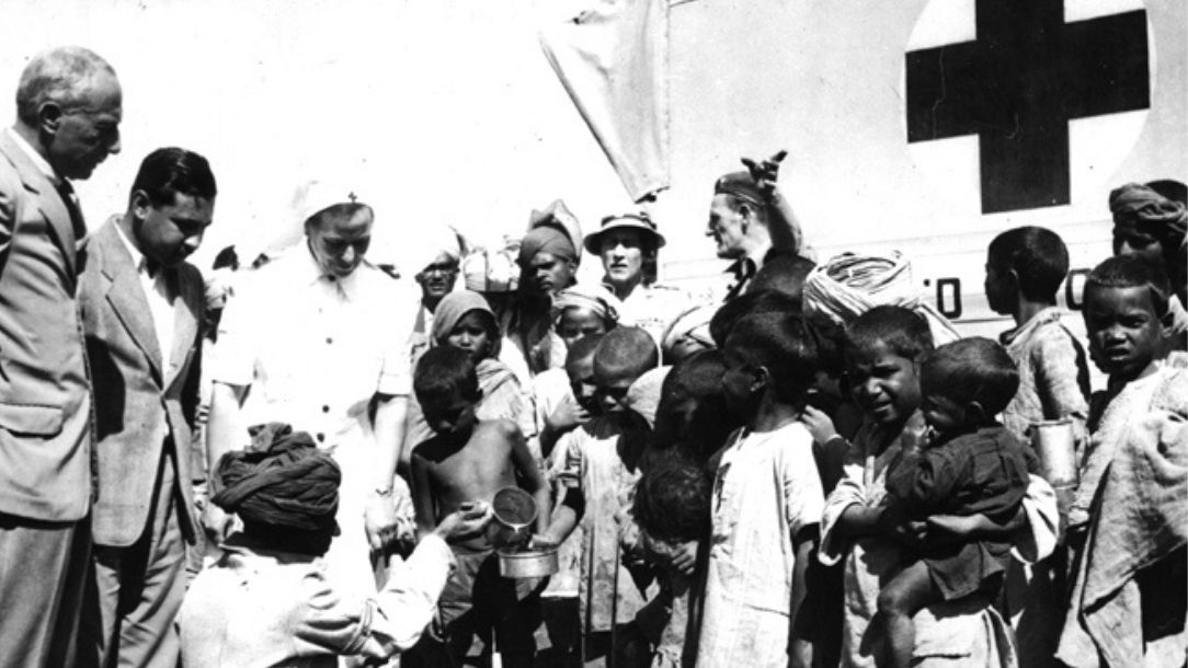 A black and white photograph showing the Red Cross distributing milk during the partition in Multan, Pakistan