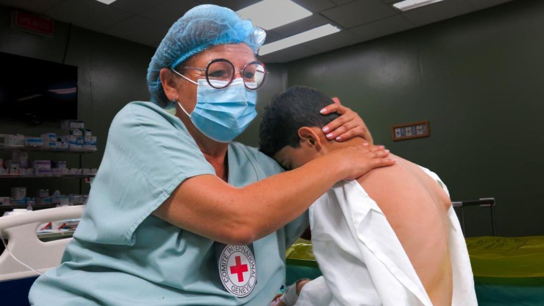 ICRC medic comforts boy in Gaza during the Israel-OPT conflict