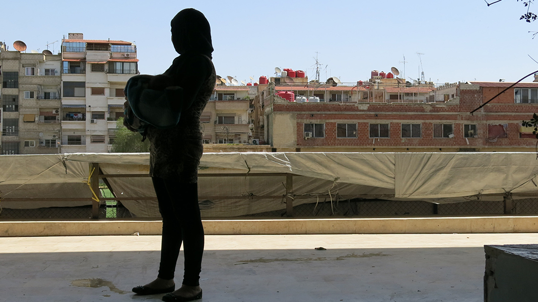 Photo showing silhouette of woman holding a baby.