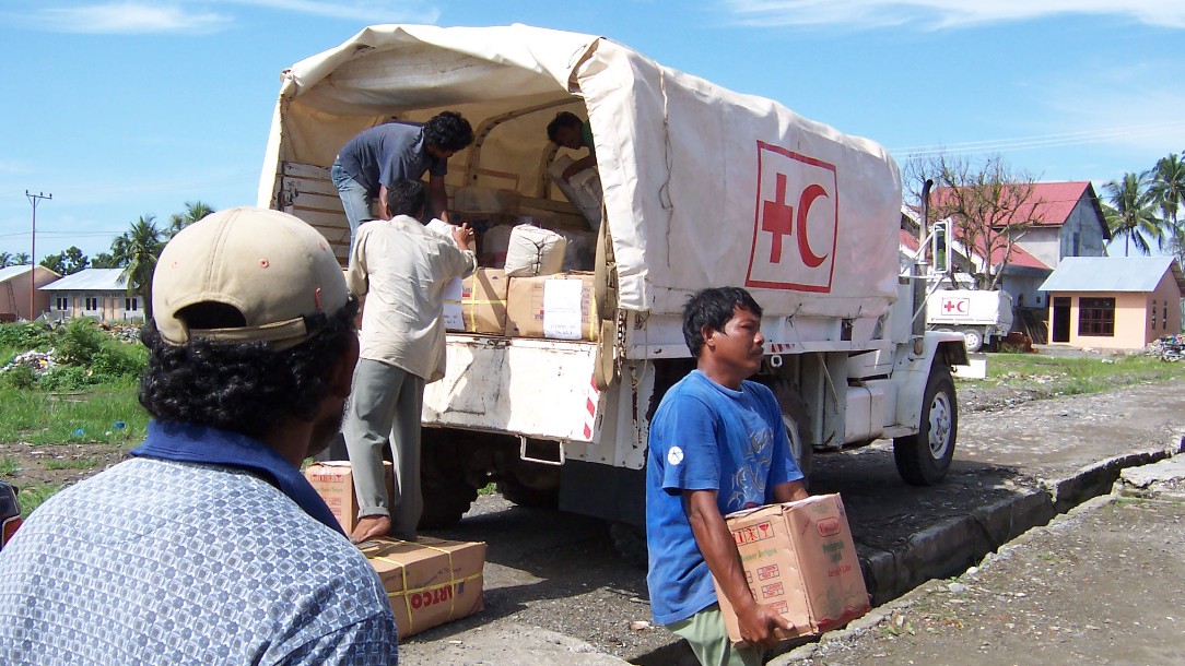 People are seen unloading parcels from a truck bearing the Red Cross emblem, in an image taken in the days following the Indian Ocean disaster of 2004