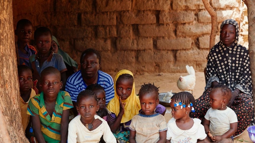 Aboutaye Magongi, 40, and her family pose outside their home in the village of Keiche, southern Niger.